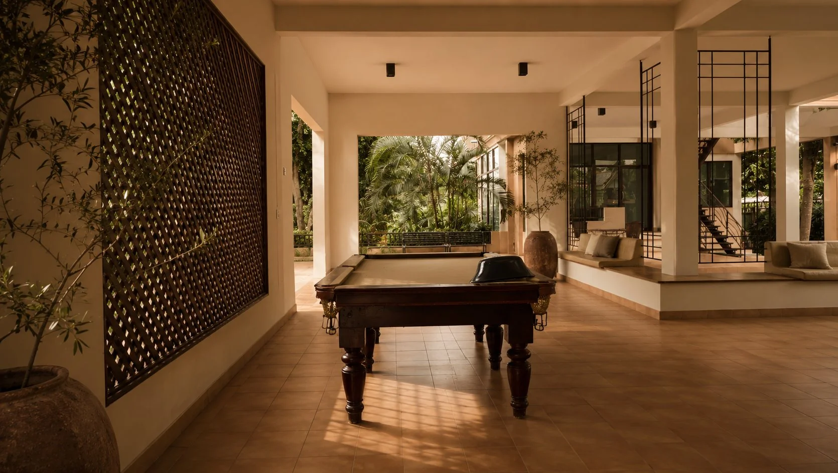 A Nibbana Shade villa beside the pool at golden hour
